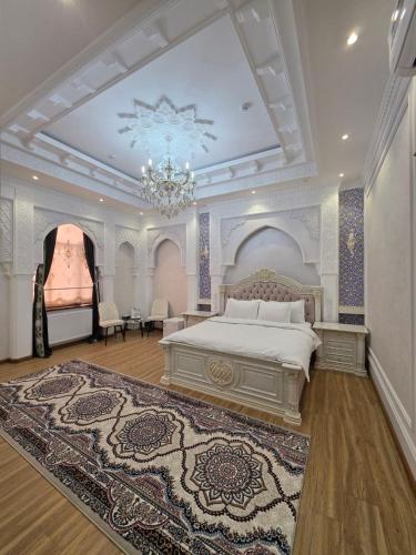a large bedroom with a bed and a chandelier at Old City Samarkand Hotel in Samarkand