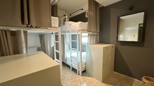 a room with a white refrigerator in a room at Jam Hostel Bangkok in Bangkok