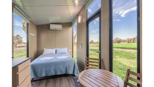 a small bedroom with a bed and a window at Avon River Homestead by Tiny Away in Beverley