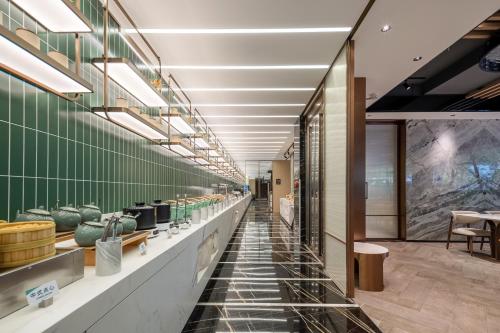 a long hallway of a store with bowls on display at Atour Hotel Shanghai Wujiaochang West Yingao Road Station in Shanghai