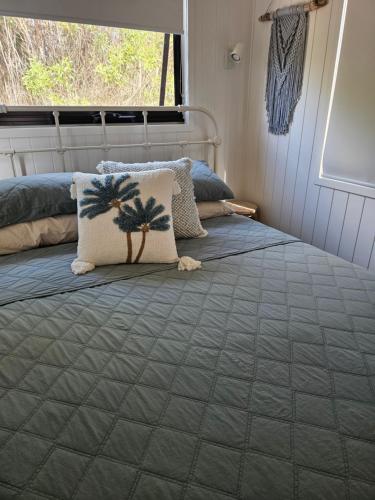 a bedroom with a bed with two pillows on it at Milfarrago Farm Stay in Farnborough