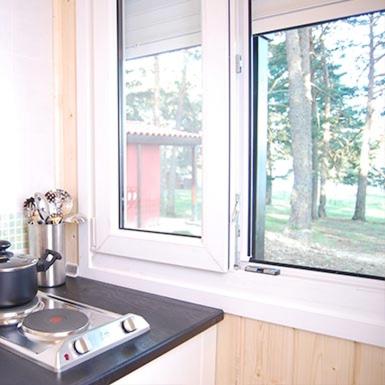 a kitchen counter with a window and a stove at Camping Urbion in Abejar