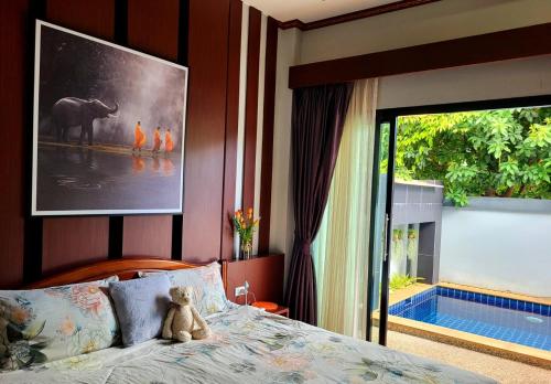 a teddy bear sitting on a bed in a bedroom at Peaceful Pool Villa 1 in Ao Nang Beach