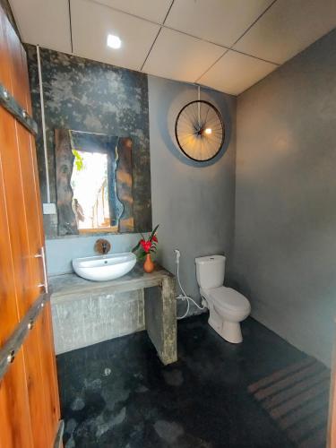 a bathroom with a sink and a toilet at Nature Rest Ashored in Sigiriya