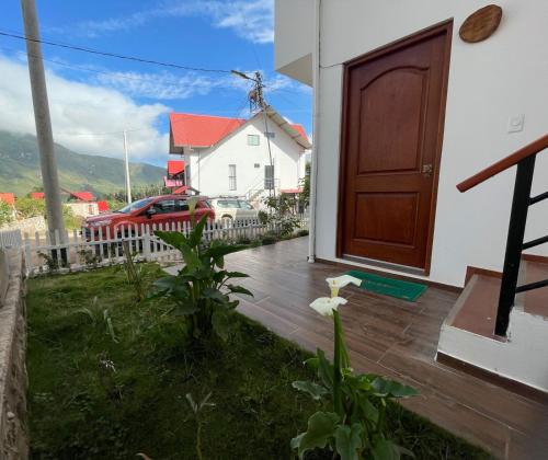 a house with a door and a yard with a house at Sweet Home Oxapampa in Oxapampa