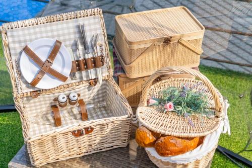 three baskets sitting on a table with food in them at Gapyeong Petite Dog Pension in Ch'ŏngp'yŏng