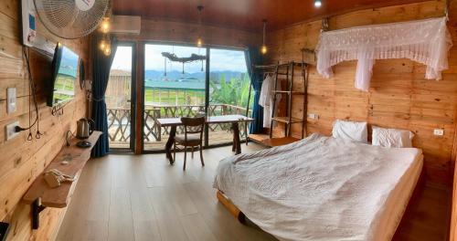 a bedroom with a bed and a table and a balcony at A Thía homestay in Diện Biên Phủ