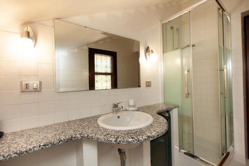 a bathroom with a sink and a mirror at Villa Acquario in Torre delle Stelle