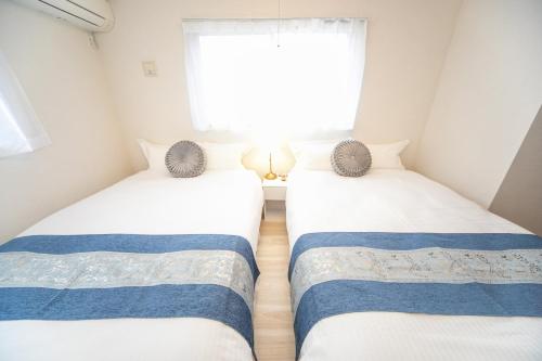 Postel nebo postele na pokoji v ubytování Nagashima Riverside Resort 5