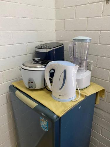 a counter with a blender and appliances on it at Brickhouse Parit Raja UTHM in Parit Raja