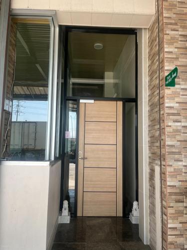 an entrance to an office building with a door at TKH The Bed in Ban Khlong Bang Krathiam
