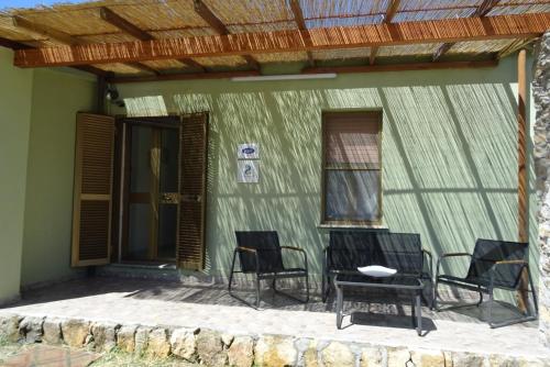 a group of chairs and a table on a patio at Casa Indipendente I DUE MARI in Porto Torres