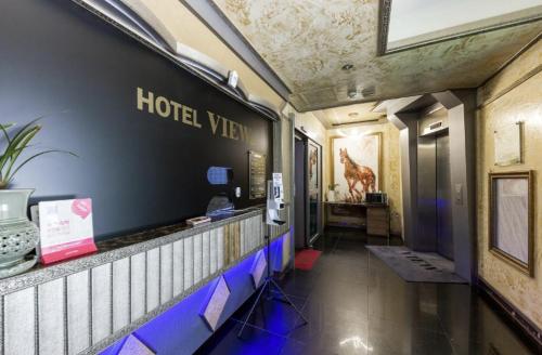 a hotel room hallway with a hotel sign on the wall at Gwangju Cheomdan View Hotel in Gwangju