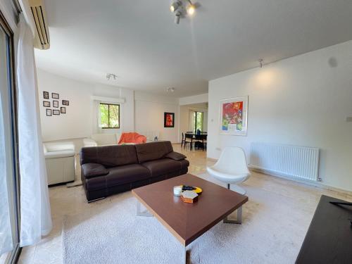 a living room with a couch and a table at Stasandrou City Center Residence in Nicosia