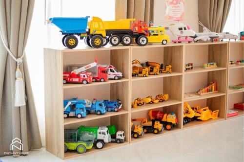 a wooden toy shelf filled with toy trucks at THE NAVY HOUSE HOTEL in Sattahip