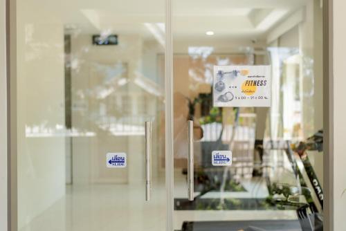 a sliding glass door with a sign on it at THE NAVY HOUSE HOTEL in Sattahip