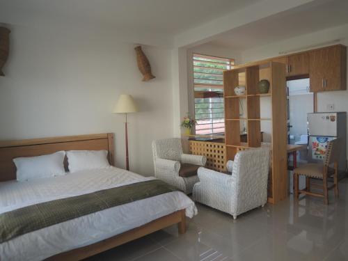 a bedroom with a bed and a chair and a desk at Sky Garden Apartment in Vung Tau