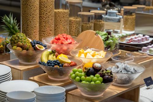 a bunch of bowls of fruit on a table at Atour Hotel Shanghai Xianxia in Shanghai