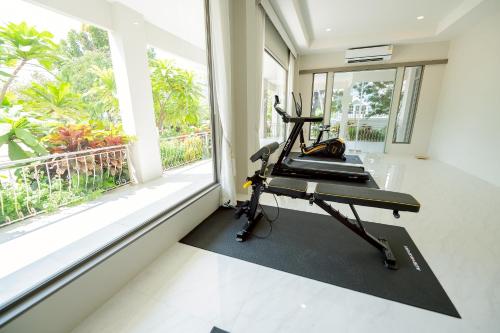 a gym with a treadmill and a large window at THE NAVY HOUSE HOTEL in Sattahip