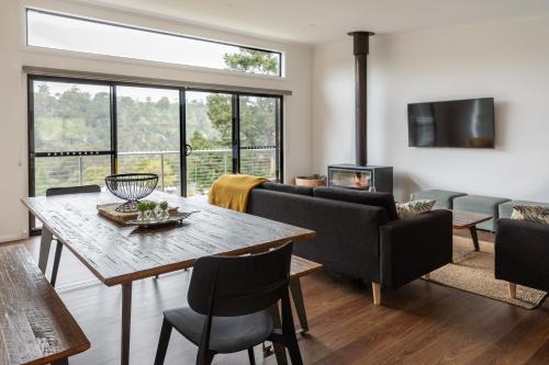 a living room with a table and chairs and a fireplace at Lake View Derby in Derby