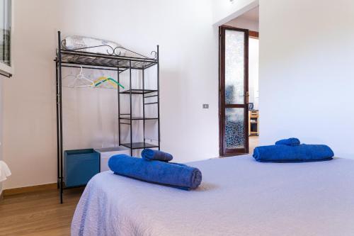 two blue pillows sitting on a bed in a room at Casa Costa degli Angeli in Santa Luria