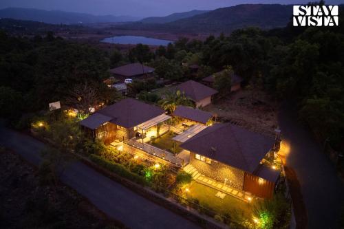 an overhead view of a house at night with lights at StayVista at Hearth & Haven with lawn, BBQ in Pune