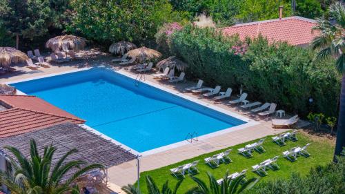 an overhead view of a swimming pool with chairs and umbrellas at Gorgona Hotel in Amoudara Herakliou