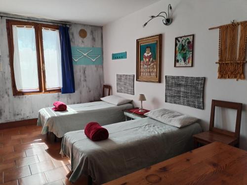 a room with three beds and a window at Stasion Di Pueste in Nogaredo Al Torre