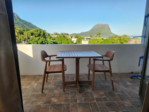 a table and two chairs on a balcony at AA Sea-view and Mountain view Apartment in La Gaulette
