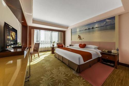 a hotel room with a large bed and a television at Hohhot Hai Liang Plaza Hotel in Hohhot