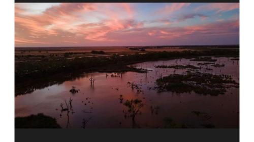 an aerial view of a river at sunset at Tiny Charm by Tiny Away in Lake Charm