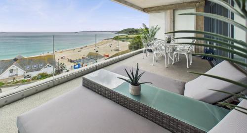 a balcony with a view of the beach at Luxury 3-bed apartment, with direct beach access, free parking & sea views ! in Falmouth