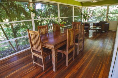 a dining room with a wooden table and chairs at Mt Bundy Station in Adelaide River