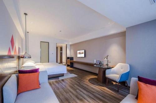 Ένα ή περισσότερα κρεβάτια σε δωμάτιο στο Borrman Hotel Nanning Railway Station