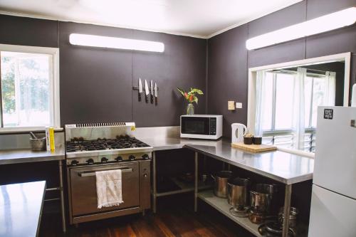 a kitchen with a stove and a microwave at Mt Bundy Station in Adelaide River