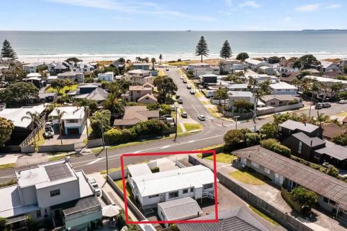 an aerial view of a suburb with the ocean at Peaceful Oasis near the Beach and Mount Mainstreet Shopping Centre in Mount Maunganui
