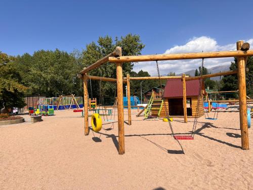 a playground with a swing set in the sand at Квартира в Радуга Плюс in Chon-Sary-Oy