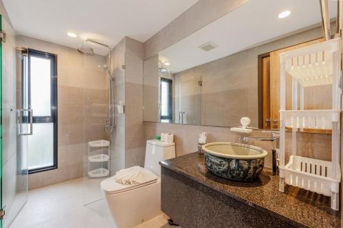 a bathroom with a sink and a toilet at C188 Modern Condo Pool Gym & Walk to Rawai Beach in Rawai Beach