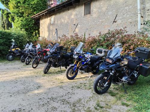 a row of motorcycles parked next to a building at Stasion Di Pueste in Nogaredo Al Torre