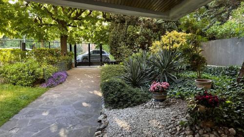 a garden with a walkway with flowers and plants at Thelissa Modern Studio - Front Metro station - Free parking in Gentilly