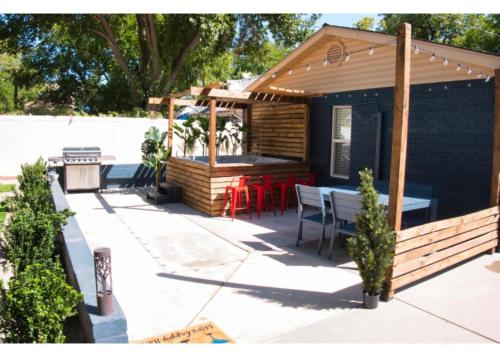 a patio with a deck with a bar at Single Story 3BR Downtown Oasis Hot Tub Mini Golf Premium Amenities in St. George