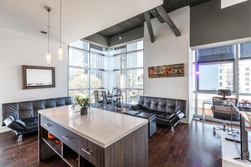 an office with leather chairs and a large room with windows at Hollywood Furnished Apartments in Los Angeles