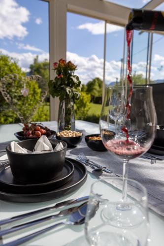 a table with a glass of wine on a table at Landhaus Fliederweg in Völkermarkt