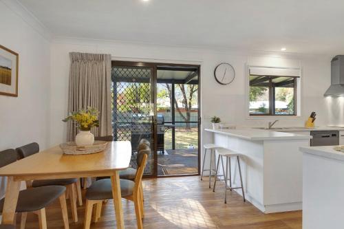 a kitchen and dining room with a table and chairs at Toorak Place in Bright