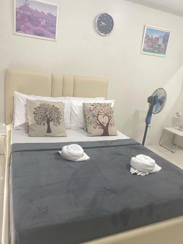 a bedroom with a bed with two hats on it at Wind and Sea at Wind Residences in Tagaytay