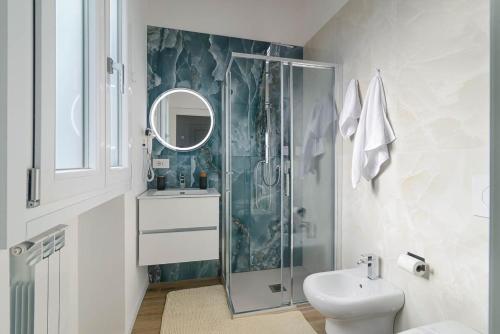 a bathroom with a shower and a sink and a toilet at La Divina Mansarda di Milano in Vittuone