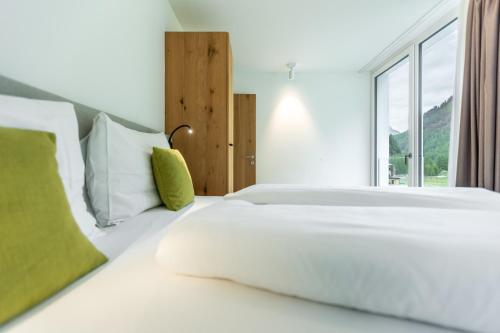 a bedroom with a large white bed with a window at keyone homes Zwieselstein in Sölden