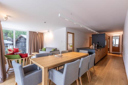 a kitchen and dining room with a wooden table and chairs at keyone homes Zwieselstein in Sölden