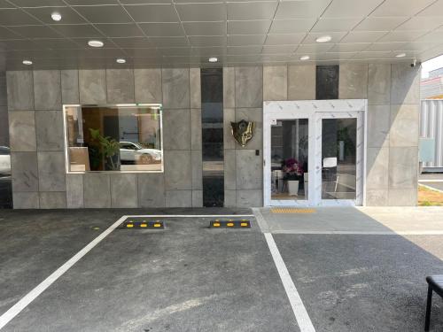 an empty parking lot with a large stone building at Road35 Hotel in Anseong