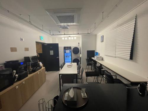 an office with tables and chairs in a room at Road35 Hotel in Anseong